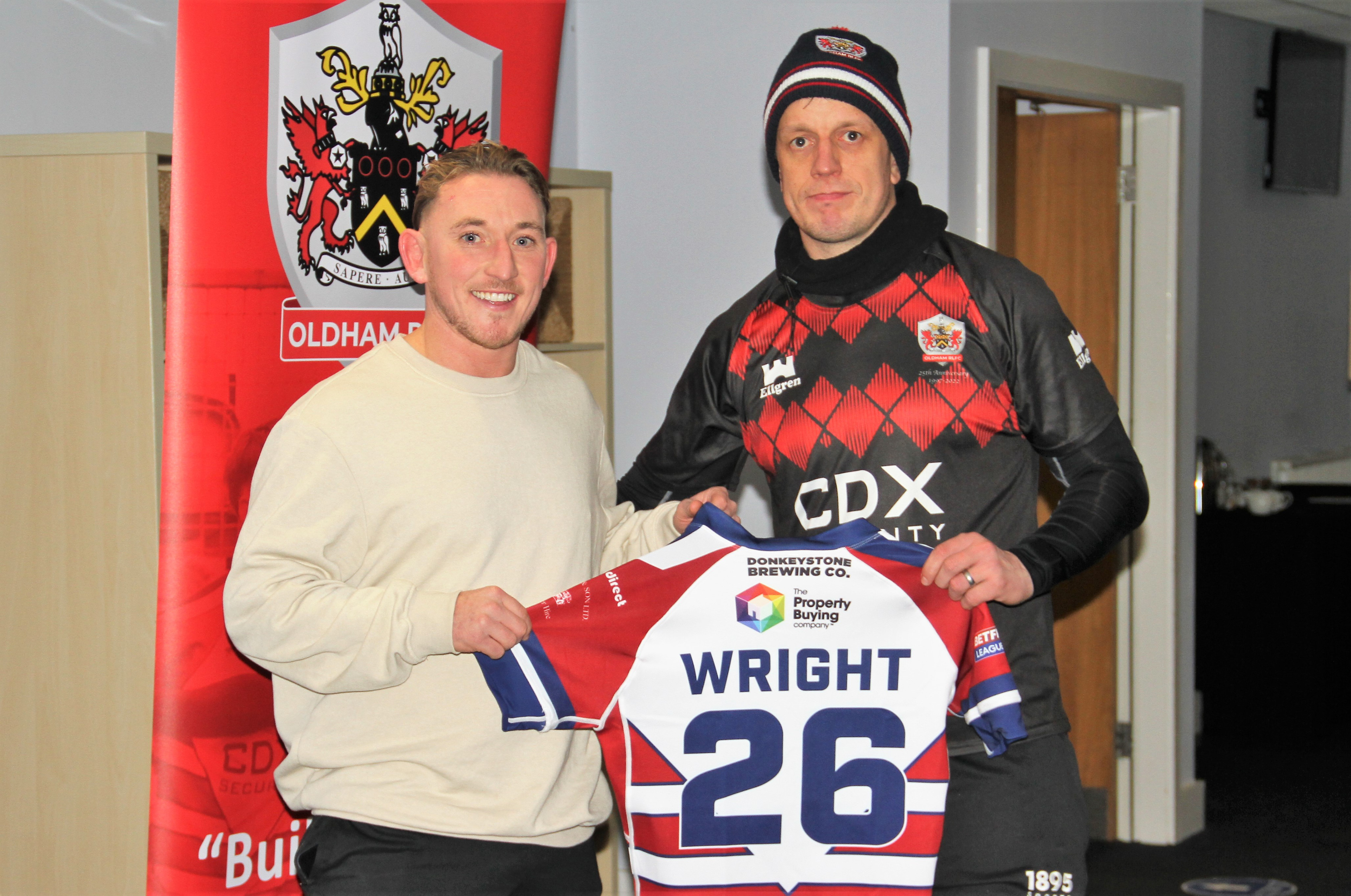 Ryan Wright receives his 2022 playing shirt from head coach Stuart Littler