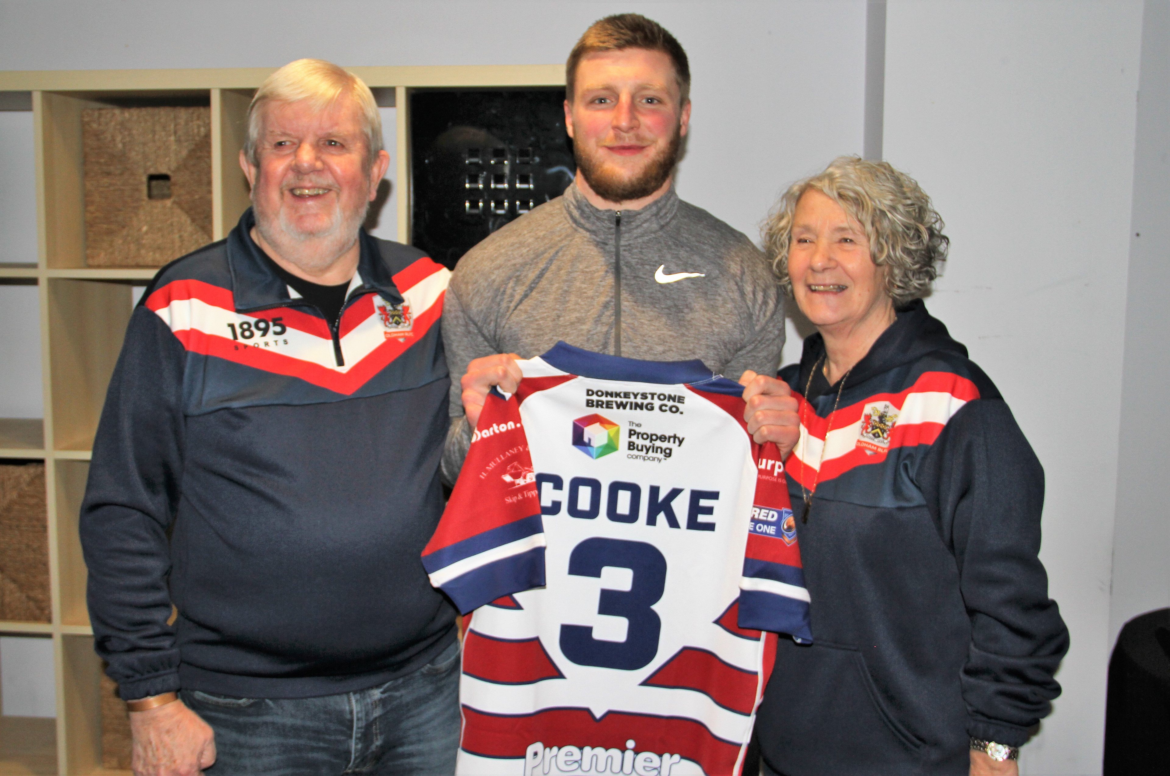 John and Lynda McAndrew with their player, centre Will Cooke